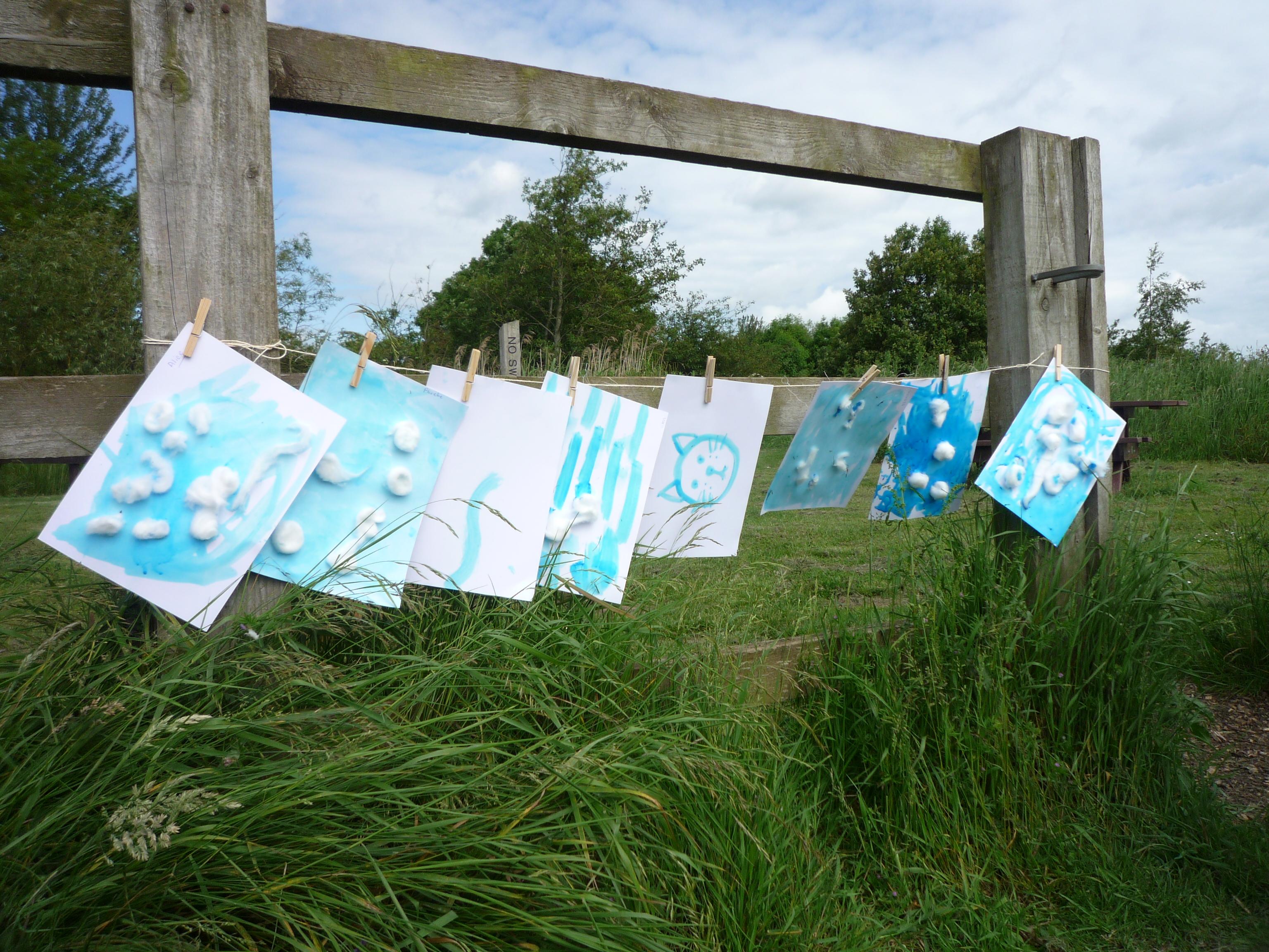 Childrens posters displayed in a woodland area