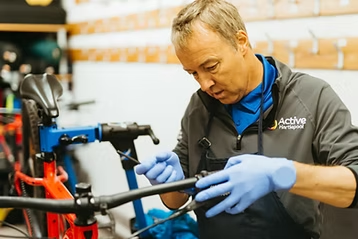 Active Hartlepool staff member fixing brakes on a bike
