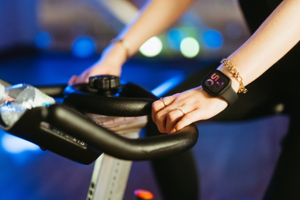 Close up of hands on exercise bike.