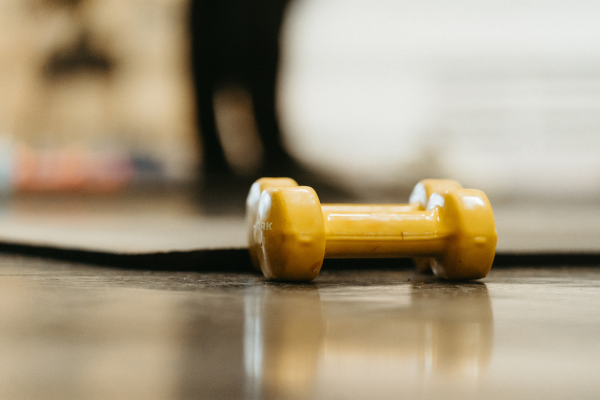 Close up shot of barbells and a yoga mat
