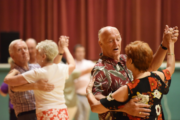 The photograph shows a man and lady dancing