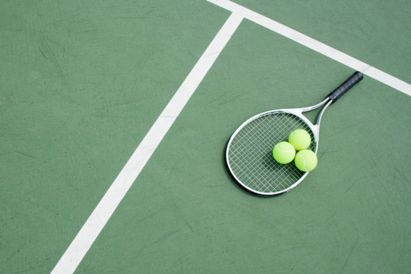 Photograph of a tennis racket and tennis balls