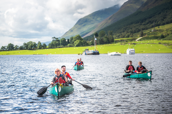 Group of people canoeing on a scenic lake