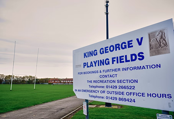 Sign for George V playing fields showing contact information